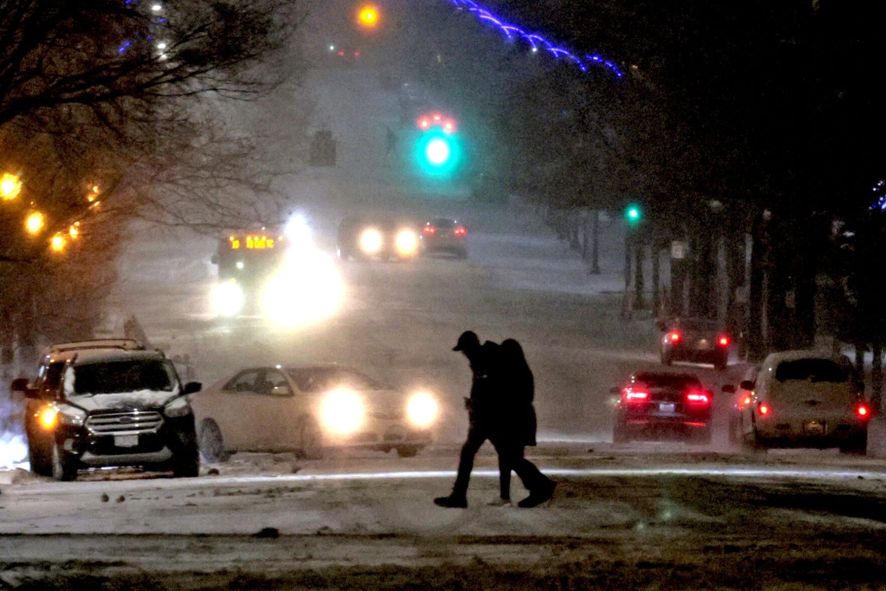 Light snow blankets streets as temperatures drop